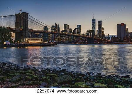 Manhattan skyline at twilight with Brooklyn Bridge, Brooklyn Bridge Park, Brooklyn; New York City, New York, United States of America View Large Photo Image Picture - Manhattan skyline at twilight with Brooklyn Bridge, Brooklyn Bridge Park, Brooklyn; New York City, New York, United States of America. Fotosearch