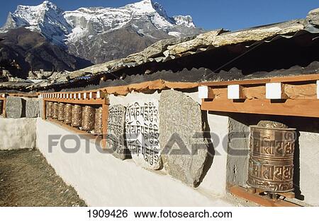 Stock Photograph - Mani Stones, Prayer Wheels And Kwande Ri,,Namche Bazaar, Nepal. Fotosearch