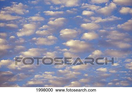 Stock Image - Many Clouds In Blue Sky. Fotosearch