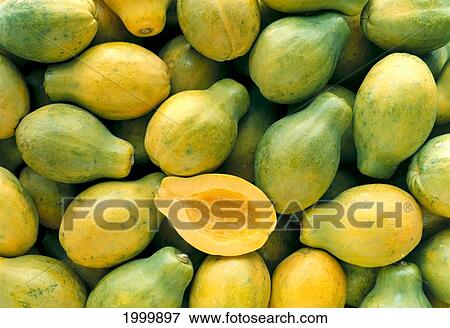 Stock Photo - Many Papayas Colors, Yellow And Green, One Cut In Half C1171. Fotosearch
