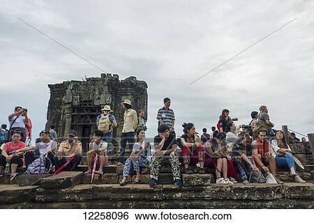 Many visitors in Phnom Bakheng, ancient buddhist temple from the famous Angkor area; Siem Reap, Cambodia View Large Photo Image Stock Photograph - Many visitors in Phnom Bakheng, ancient buddhist temple from the famous Angkor area; Siem Reap, Cambodia. Fotosearch