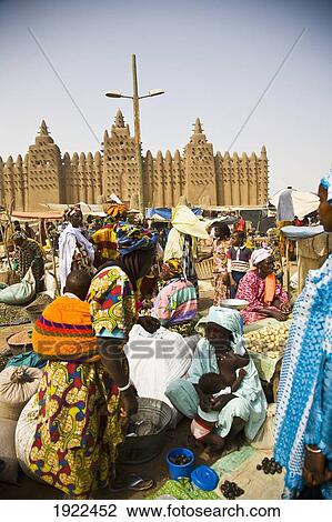 Stock Image - Market Place With Djenne Mosque In Background. Fotosearch