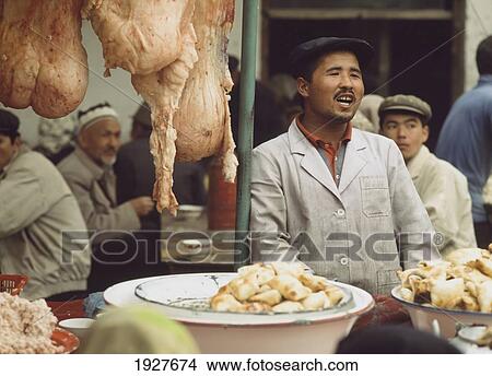 Picture - Market Vendor Behind Stall. Fotosearch