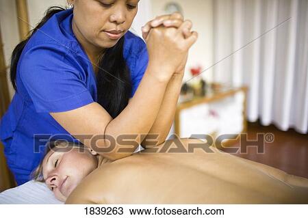 Masseuse Giving Back Massage With Elbows To Woman; Puerto Gallera, Mindoro Island, Philippines View Large Photo Image Stock Image - Masseuse Giving Back Massage With Elbows To Woman; Puerto Gallera, Mindoro Island, Philippines. Fotosearch