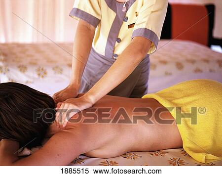 Stock Photography - Masseuse Massaging Woman's Back. Fotosearch
