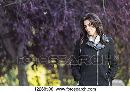Mature businesswoman walking outdoors in a city park in autumn; Edmonton, Alberta, Canada View Large Photo Image Stock Photo - Mature businesswoman walking outdoors in a city park in autumn; Edmonton, Alberta, Canada. Fotosearch