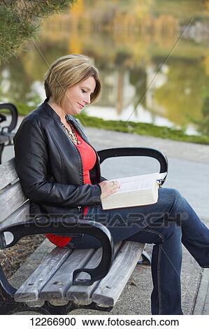 Mature Christian woman studying her Bible in a park; Edmonton, Alberta, Canada View Large Photo Image Stock Image - Mature Christian woman studying her Bible in a park; Edmonton, Alberta, Canada. Fotosearch