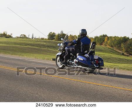Mature man riding a motorcycle on highway; Edmonton, Alberta, Canada View Large Photo Image Stock Photo - Mature man riding a motorcycle on highway; Edmonton, Alberta, Canada. Fotosearch