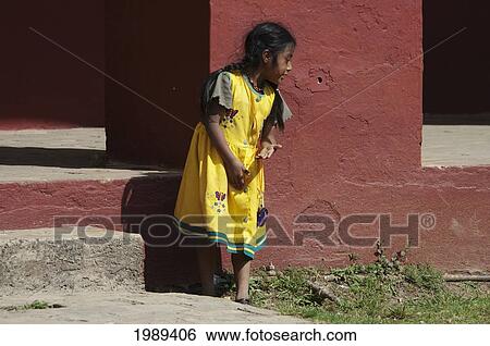 Stock Photograph - Maya Girl Playing In The Courtyard Of The Santo Domingo Church, San Cristobel De Las Casas, Chiapas, Mexico. Fotosearch