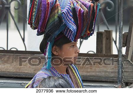 Stock Photograph - Maya Woman Carrying Textiles On Her Head, Panajachel, Solol. Fotosearch