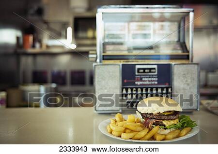 Stock Image - Meal With Jukebox In Docklands; London, Uk. Fotosearch