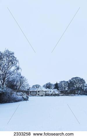 Stock Photo - Medieval House And Snowy Field; Great Wilbraham, Cambridgeshire, England, Uk. Fotosearch