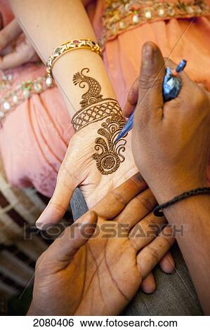 Stock Photograph - Mehndi Being Put On A Woman's Hand; Ludhiana, Punjab, India. Fotosearch