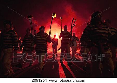 Picture - Members Of Borough Bonfire Society Lit From Behind By Flare Marching In Procession At Hastings Bonfire Night, East Sussex, Uk. Fotosearch