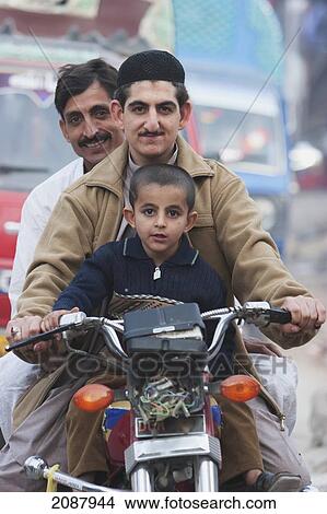 Picture - Men And Boy On A Motorcycle, Muzaffarabad, Azad Kashmir, Pakistan. Fotosearch