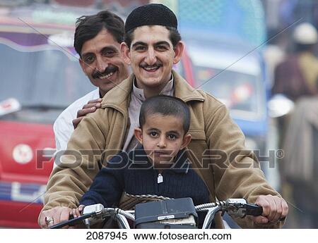 Stock Photography - Men And Boy On A Motorcycle, Muzaffarabad, Azad Kashmir, Pakistan. Fotosearch