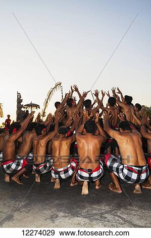 Stock Photo - Men dancing in a circle chanting in trance during a Kecak dance performance, Ulu Watu, Bali, Indonesia. Fotosearch