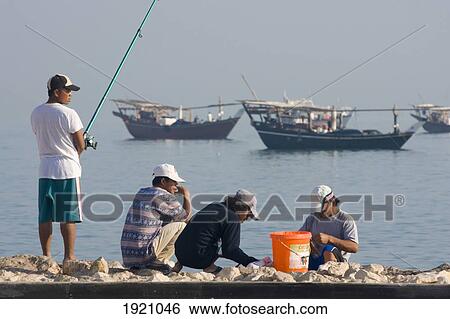 Stock Photograph - Men Fishing At Al Wakrah Port, Qatar. Fotosearch