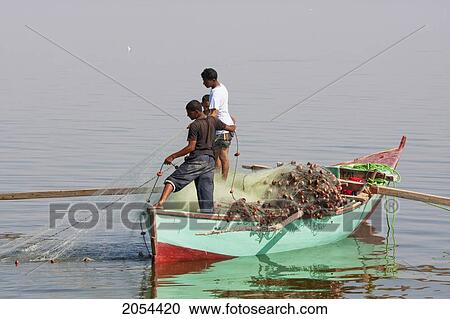 Stock Image - Men Fishing From A Boat, Lake Qarun, El Fayoum, Egypt. Fotosearch