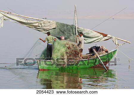 Stock Image - Men Fishing From A Boat, Lake Qarun, El Fayoum, Egypt. Fotosearch