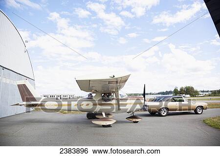 Men in airplane by hangar and car; Langley, British Columbia, Canada View Large Photo Image Stock Photograph - Men in airplane by hangar and car; Langley, British Columbia, Canada. Fotosearch