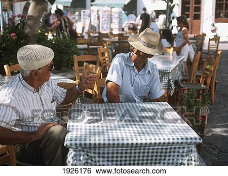 Stock Photograph - Men In Cafe; Patmos Island, Greece. Fotosearch