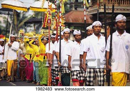 Stock Image - Men on a pilgrimage for an offering at a religious festival; Bali. Fotosearch