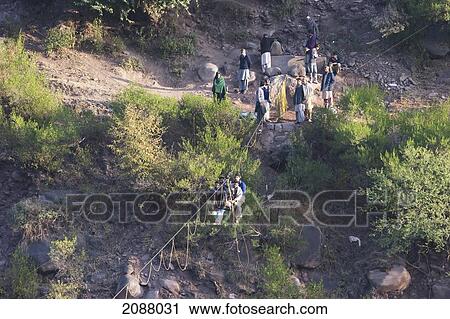 Men On A Ropeway Over The Jhelum River After The 8 October 2005 Earthquake, Azad Kashmir, Pakistan View Large Photo Image Stock Image - Men On A Ropeway Over The Jhelum River After The 8 October 2005 Earthquake, Azad Kashmir, Pakistan. Fotosearch