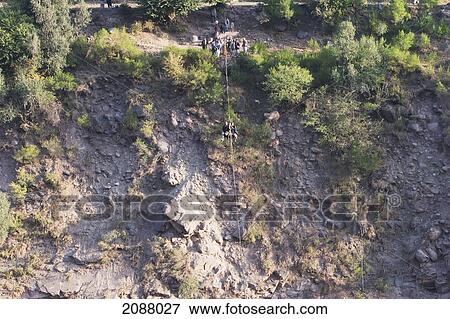 Men On A Ropeway Over The Jhelum River After The 8 October 2005 Earthquake, Azad Kashmir, Pakistan View Large Photo Image Stock Photo - Men On A Ropeway Over The Jhelum River After The 8 October 2005 Earthquake, Azad Kashmir, Pakistan. Fotosearch