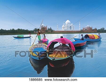 Stock Photography - Men On Boats On River In Front Of The Taj Mahal. Fotosearch