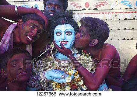 Stock Photograph - Men painted red during Holi festival; Kolkata, West Bengal, India. Fotosearch