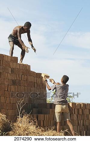 Men Piling Bricks For Firing In Antsokay, Toliara Province, Madagascar View Large Photo Image Stock Image - Men Piling Bricks For Firing In Antsokay, Toliara Province, Madagascar. Fotosearch