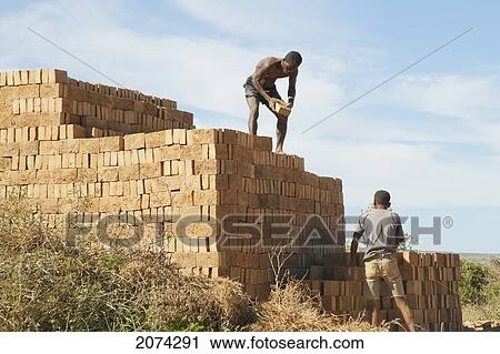 Men Piling Bricks For Firing In Antsokay, Toliara Province, Madagascar View Large Photo Image Stock Image - Men Piling Bricks For Firing In Antsokay, Toliara Province, Madagascar. Fotosearch