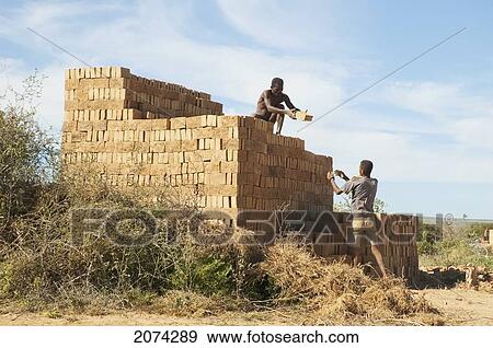Men Piling Bricks For Firing In Antsokay, Toliara Province, Madagascar View Large Photo Image Stock Photo - Men Piling Bricks For Firing In Antsokay, Toliara Province, Madagascar. Fotosearch