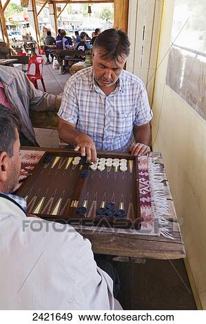 Stock Photo - Men playing backgammon; Urgup, Cappadocia, Turkey. Fotosearch