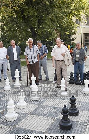 Men playing chess on Trg Oslobodjenje (Liberation Square), Sarajevo, Bosnia and Herzegovina View Large Photo Image Stock Photo - Men playing chess on Trg Oslobodjenje (Liberation Square), Sarajevo, Bosnia and Herzegovina. Fotosearch