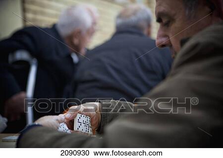 Stock Image - Men Playing Dominoes Game In The Sha'ab Chai Khana [Teahouse], Sulaymaniyah, Iraqi Kurdistan, Iraq. Fotosearch