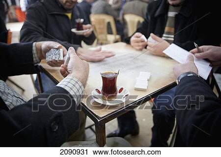 Stock Image - Men Playing Dominoes Game In The Sha'ab Chai Khana [Teahouse], Sulaymaniyah, Iraqi Kurdistan, Iraq. Fotosearch