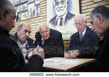 Stock Image - Men Playing Dominoes Game In The Sha'ab Chai Khana [Teahouse], Sulaymaniyah, Iraqi Kurdistan, Iraq. Fotosearch