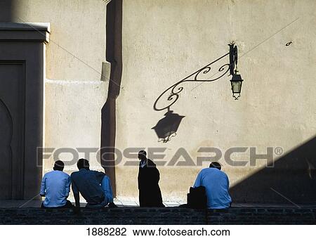 Men Relaxing In Shadow Of Koutoubia Mosque View Large Photo Image Stock Image - Men Relaxing In Shadow Of Koutoubia Mosque. Fotosearch