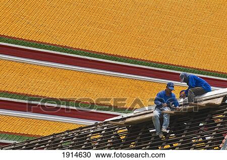 Stock Image - Men Repairing Roof Of Wat Pho Temple. Fotosearch