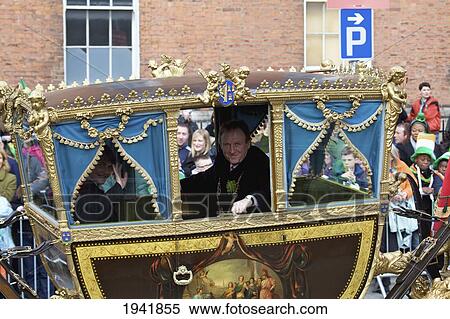 Stock Photography - Men Riding In A Carriage Float In The Saint Patrick's Day Parade; Dublin Ireland. Fotosearch