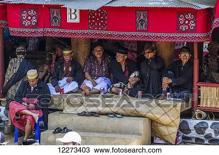 Men sitting in a temporary shelter, attending a funeral ceremony at a rante, the ceremonial site for a Torajan funeral, in Sereale, Toraja Land, South Sulawesi, Indonesia View Large Photo Image Stock Image - Men sitting in a temporary shelter, attending a funeral ceremony at a rante, the ceremonial site for a Torajan funeral, in Sereale, Toraja Land, South Sulawesi, Indonesia. Fotosearch