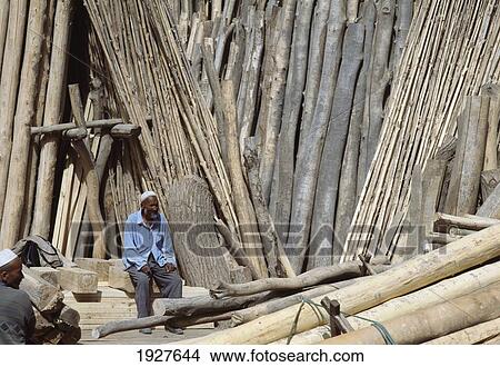 Men Sitting In Yard With Lots Of Timber View Large Photo Image Picture - Men Sitting In Yard With Lots Of Timber. Fotosearch