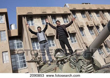 Stock Image - Men Standing On Canon In Front Of The Amna Suraka (Red Security) Museum. Fotosearch