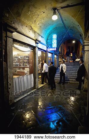 Men Standing Outside The Entrance Of A Bar At Night; Venice Venezia Italy View Large Photo Image Stock Photo - Men Standing Outside The Entrance Of A Bar At Night; Venice Venezia Italy. Fotosearch