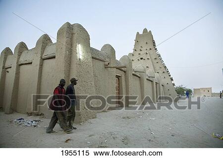 Stock Photography - Men Walking In Front Of Sankore Mosque, Timbuktu, Mali. Fotosearch