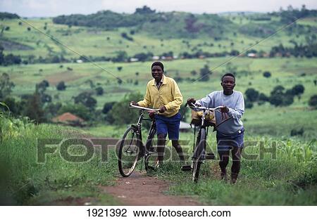 Stock Image - Men With Bikes. Fotosearch