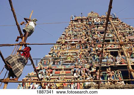 Stock Image - Men Working On Scaffolding In Front Of Kapaleeshwarar Temple. Fotosearch