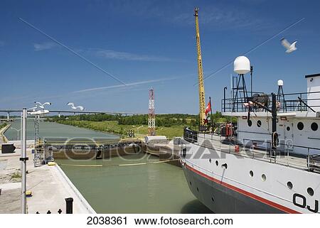Merchant Ship Going Through A Lock; St. Catharines Ontario Canada View Large Photo Image Stock Image - Merchant Ship Going Through A Lock; St. Catharines Ontario Canada. Fotosearch